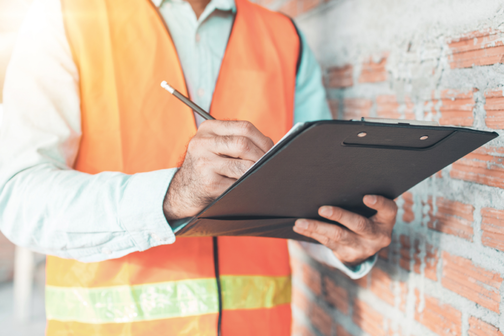 A Metalworking Employee With A Check List - Arrow Machine And Fabrication Group